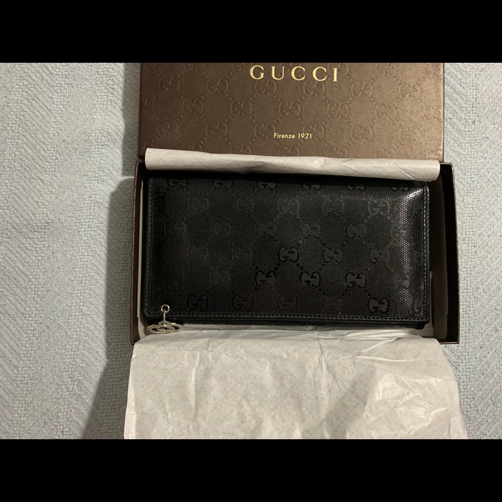Gucci long wallet clutch with snap button front.